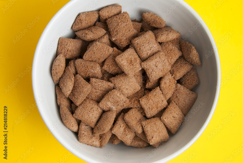 Breakfast corn chocolate pillows. Delicious breakfast. Isolated over yellow background. Top view. Breakfast corn chocolate pillows. Delicious breakfast. Isolated over yellow background. Top view.
