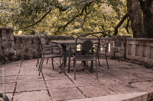 old metal table in old cafe. Siesta table and chairs on the masard