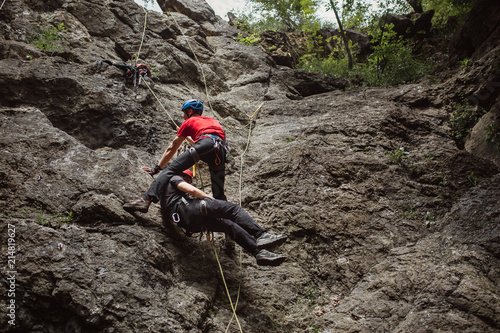 Mountain rescuer helping injured climber 