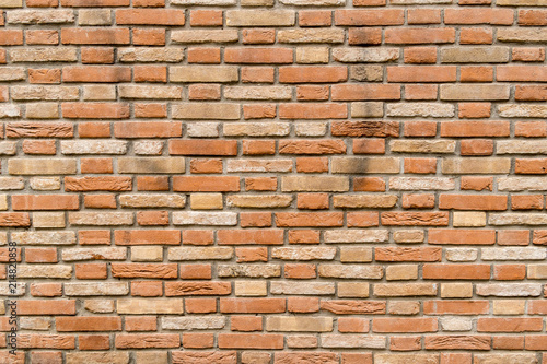 Old and damaged brown brick wall