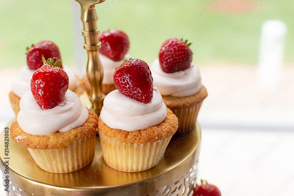 Gourmet Vanilla Cupcakes With Glazed Strawberry toppers.