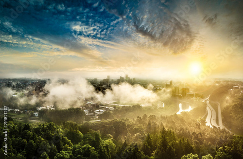 Vilnius city in fog and clouds in summer morning