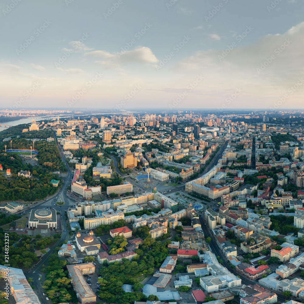 Panorama of the city of Kiev at sunset. A modern metropolis in the center of Europe against the backdrop of sunset sky from a bird's eye view. Aerial view. Panorama of the Tourist Center of Kiev.