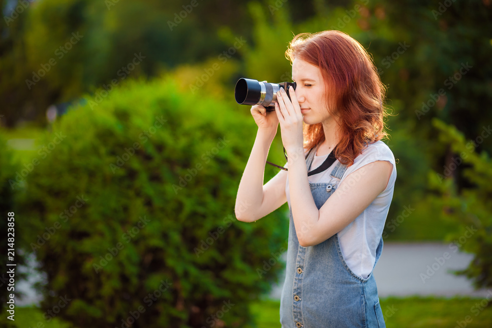 Red-haired girl photographer in the Park Red-haired girl photographer in the Park