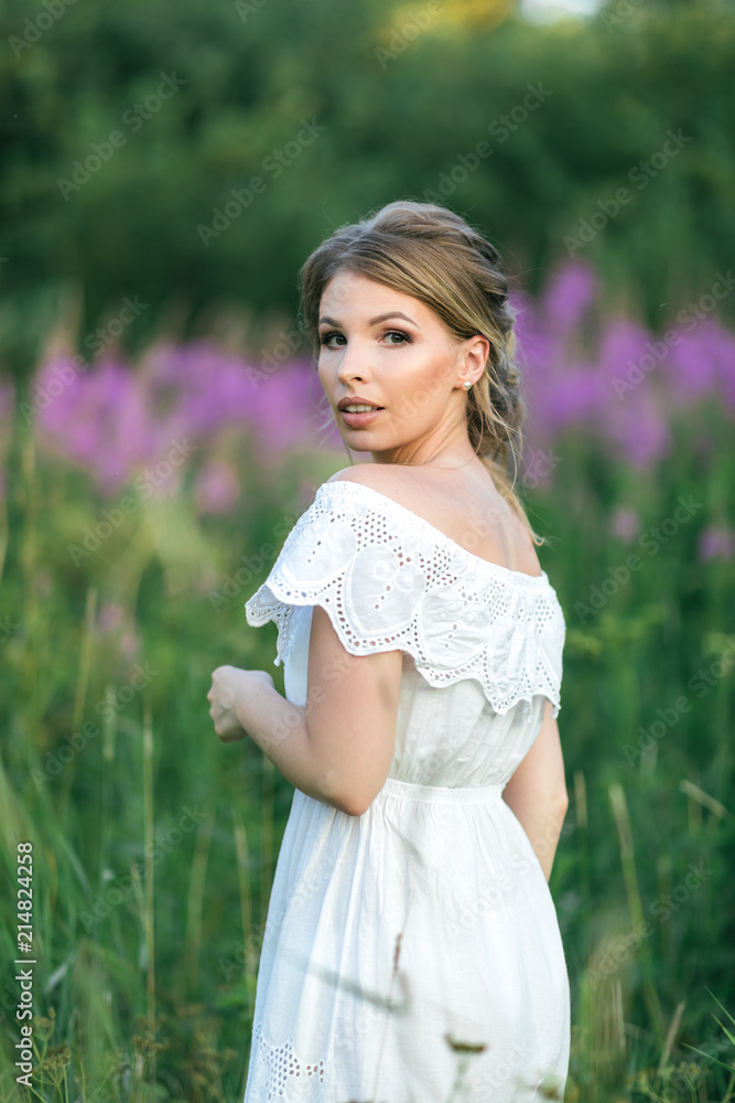 Beautiful young happy girl in the blossoming fields, thinking about her life and goals. Slow life, minimalism, mindfulness Beautiful young happy girl in the blossoming fields, thinking about her life and goals. Slow life, minimalism, mindfulness