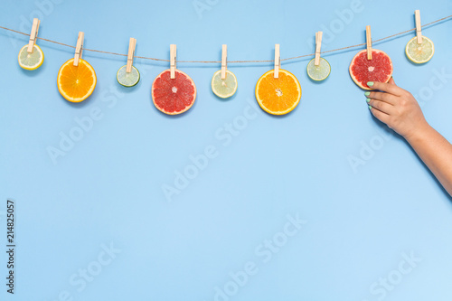 Slices of orange, grapefruit, lemon and lime hanging on a rope