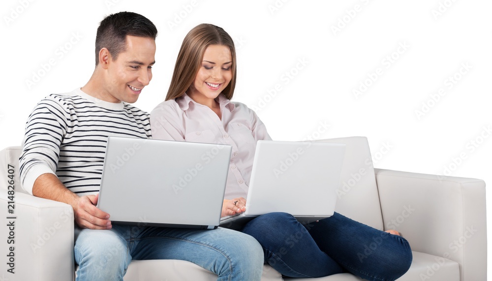 Smiling Couple Using Laptop on the Couch Smiling Couple Using Laptop on the Couch