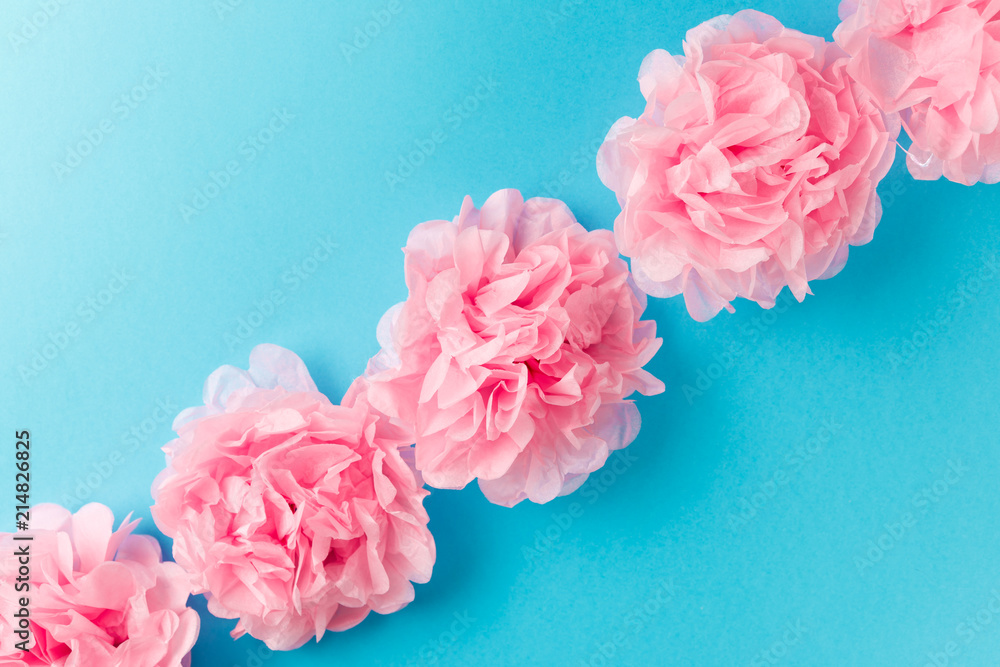 Pink flower pattern on blue pastel background. Minimal spring concept. Flat lay. Top view Pink flower pattern on blue pastel background. Minimal spring concept. Flat lay. Top view
