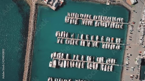 Aerial, top down view of luxury boats in marina.