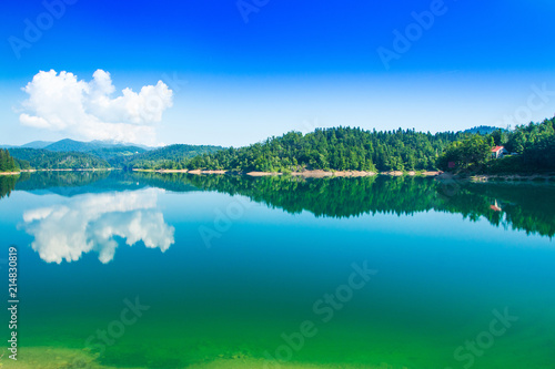 Fototapeta Naklejka Na Ścianę i Meble -  Green lake in Gorski kotar, Lokve, Croatia, with Risnjak mountain in background, reflection in watter 