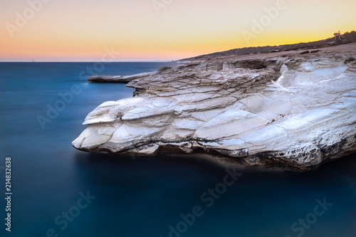 Alamanos white rocks by the sea, during sunset photo