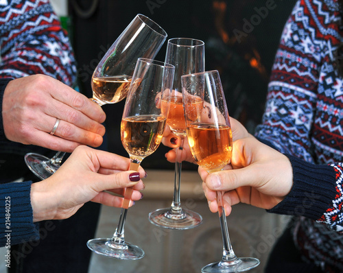Four glasses with champagne in a friendly company. Close-up
