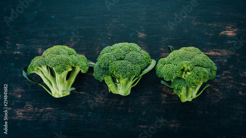 Fresh green broccoli. Raw Vegetables. On a wooden background. Top view. Copy space.