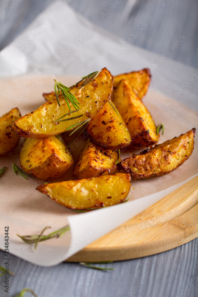 grilled potatoes rosemary wooden background
