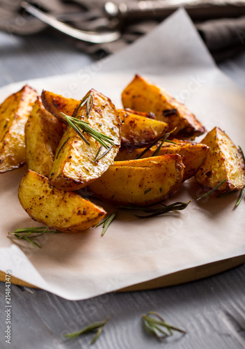 grilled potatoes rosemary wooden background
