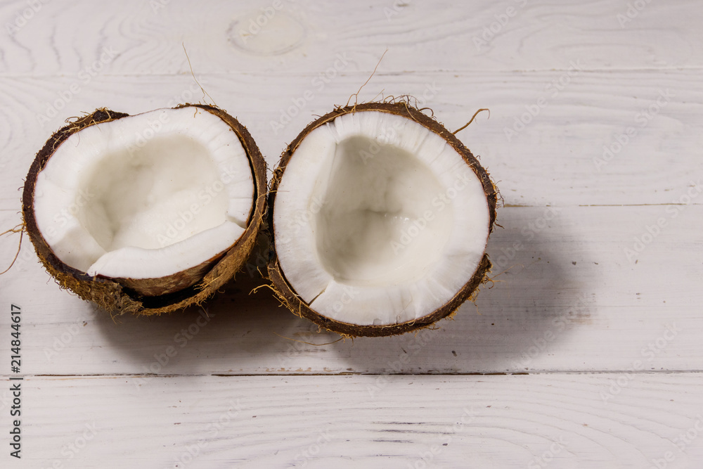 Fresh ripe coconut on white wooden table Fresh ripe coconut on white wooden table