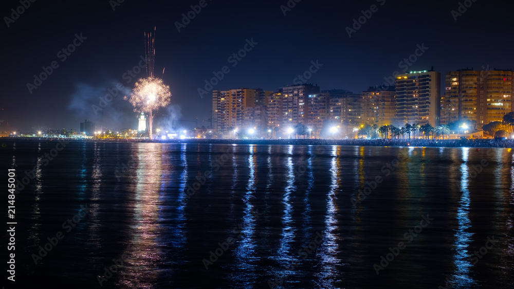 The Malagueta beach at night time with fireworks in Malaga, Spain