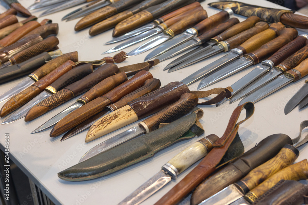Hunting and fighting knives lying on the counter. Steel arms Hunting and fighting knives lying on the counter. Steel arms