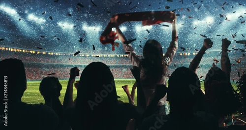 Fans celebrating the success of their favorite sports team on the stands of the professional stadium while it's snowing. Stadium is made in 3D and animated.