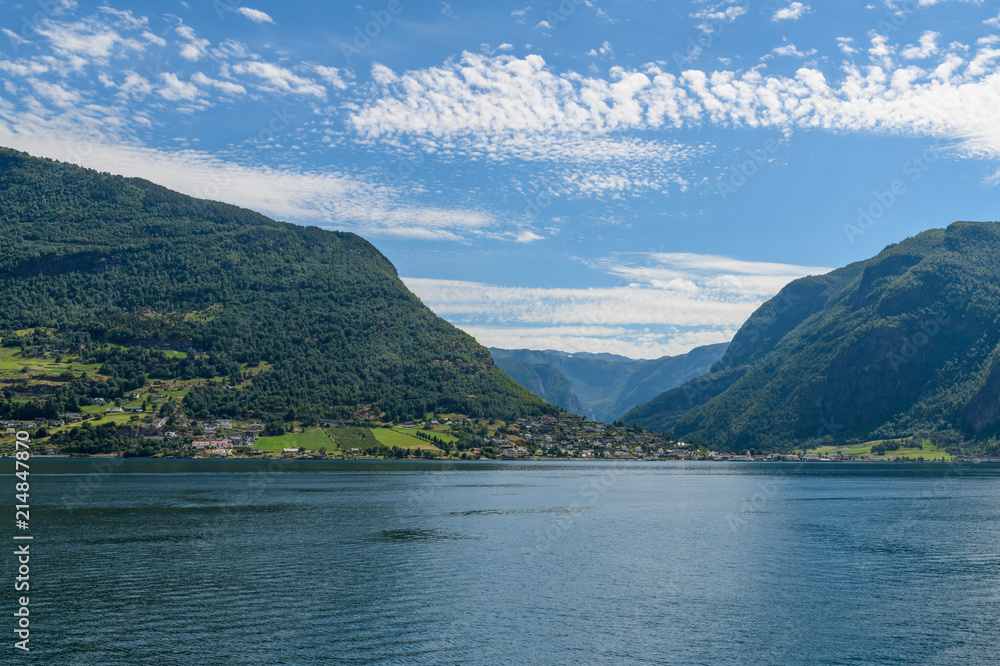 View from the fjord towards the village of Flom.  Neroyfjord offshoot of Sognefjord is the narrowest fjord in Europe. Sogn og Fjordane,  Norway, Europe.