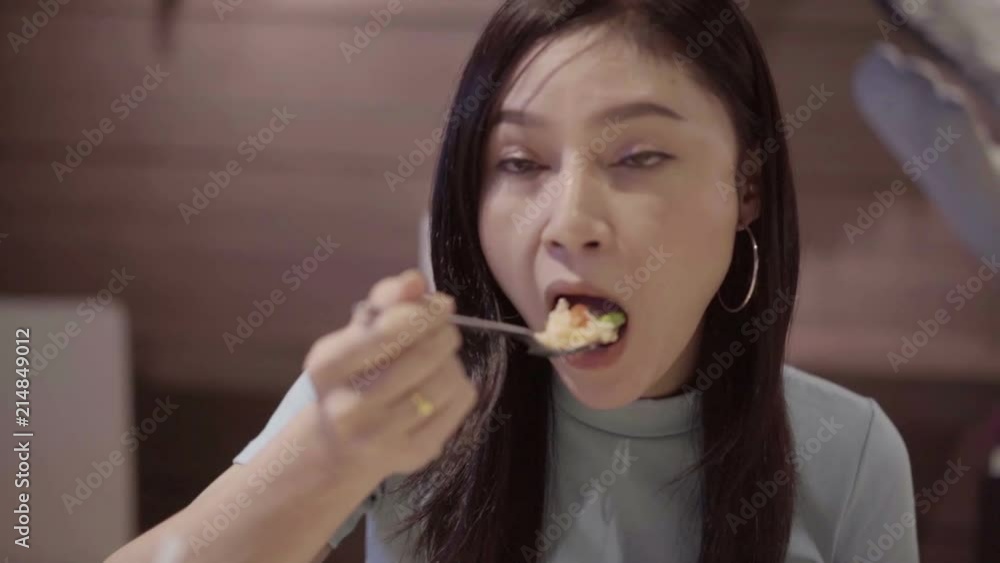 slow-motion of woman is eating rice food slow-motion of woman is eating rice food