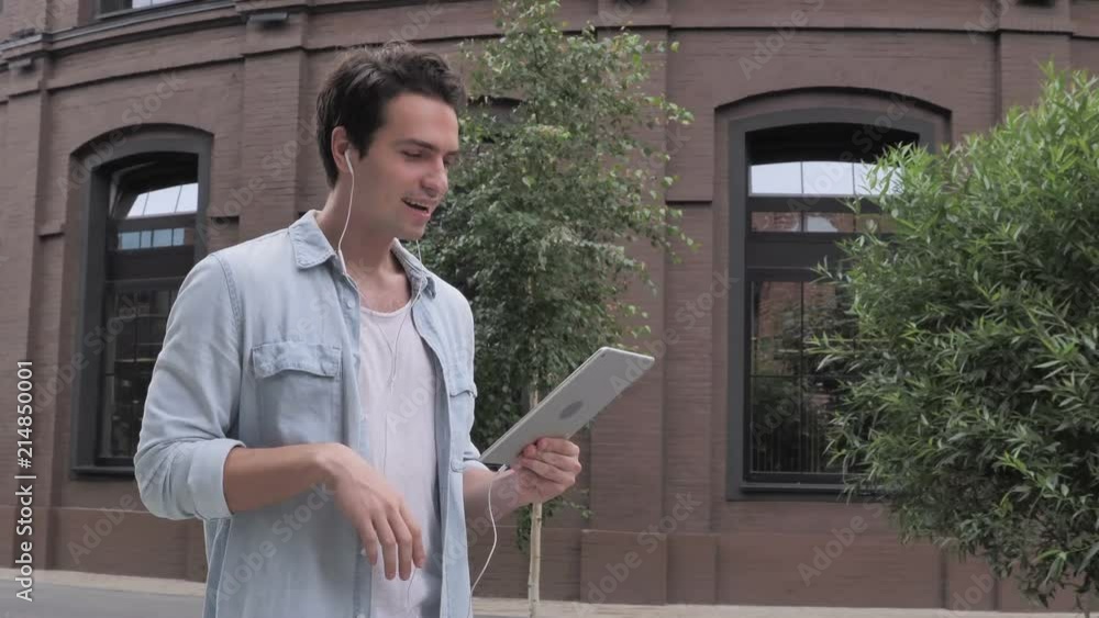 Online Video Chat on Tablet by Walking Man on Street Online Video Chat on Tablet by Walking Man on Street