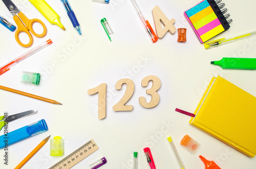 mathematics. numbers 1, 2, 3 on the school desk. concept of education. back to school. stationery. White background. stickers, colored pens, pencils, scissors. view from above. flat lay.