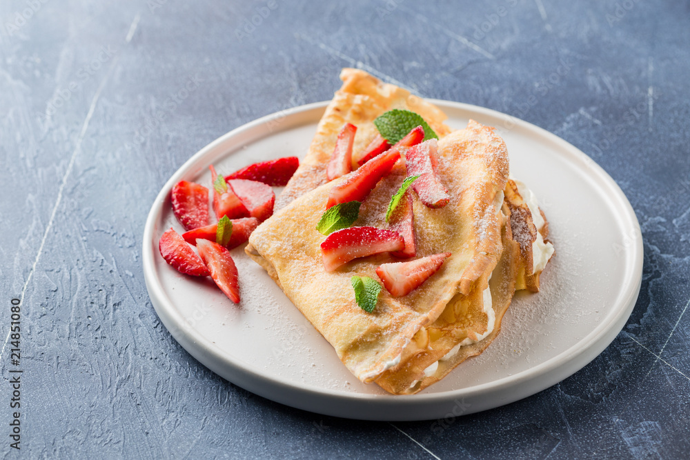 Crepes with strawberries and cream. Close up Crepes with strawberries and cream. Close up