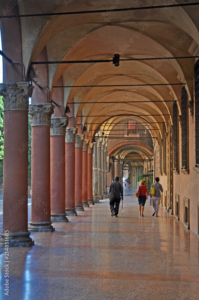 Bologna, Italy, local and tourists walking in Santo Stefano square portico. 