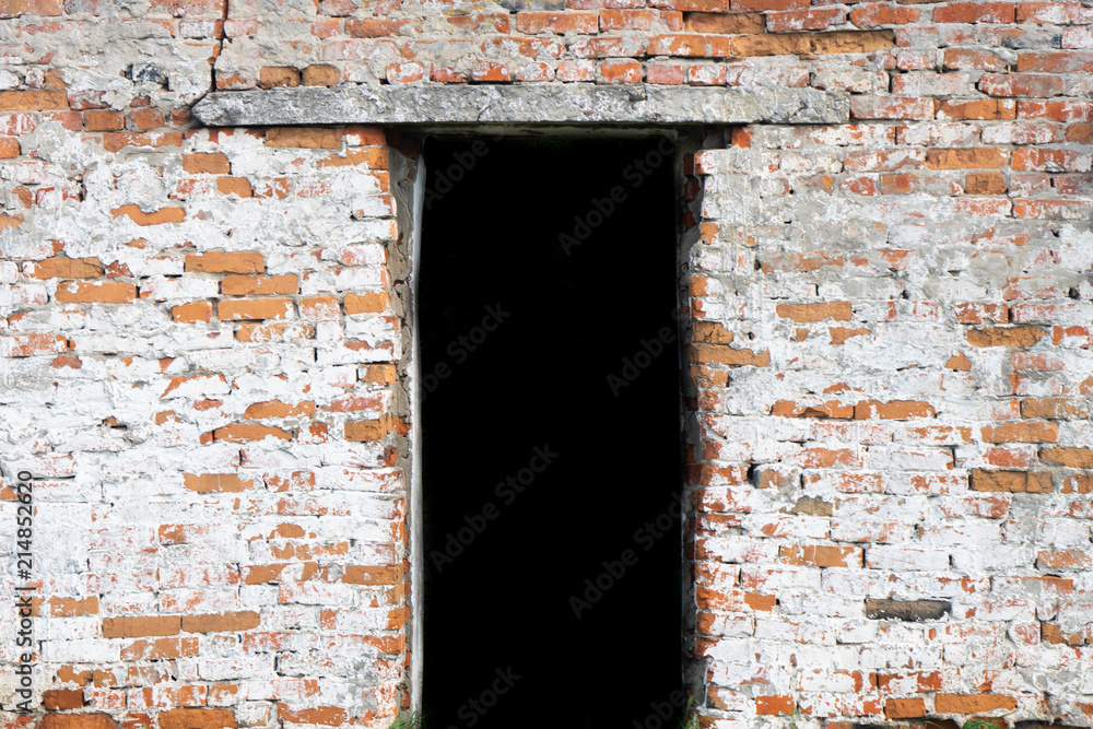 An old ruined brick building with a doorway. An old ruined brick building with a doorway.