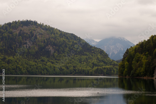 Germany, the Alpsee Lake, surrounded by hilly terrain