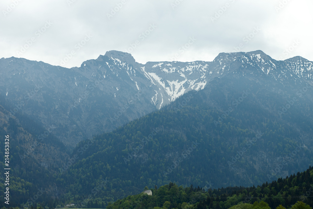 Naklejka premium landscape in the Alps with snow-capped mountain peaks in the background, Bavaria, Germany