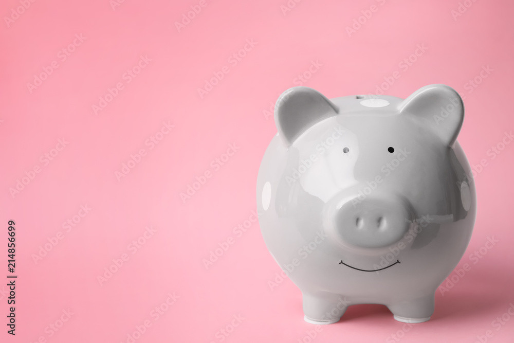 Gray piggy bank on color background. Money saving