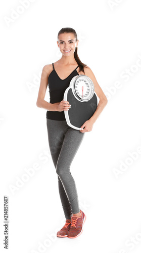 Happy young woman with scales on white background. Weight loss motivation © New Africa
