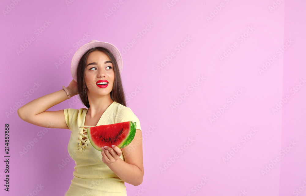Beautiful young woman posing with watermelon on color background Beautiful young woman posing with watermelon on color background
