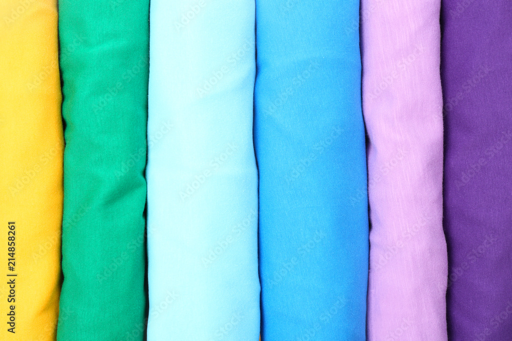Many trendy colorful t-shirts, close up view