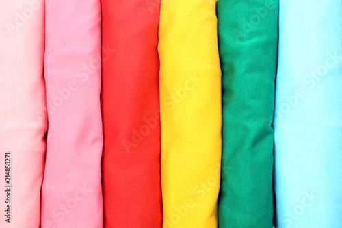 Many trendy colorful t-shirts, close up view