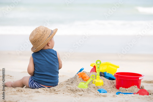 Asian baby boy playing sand on the beach, Baby 1 year old