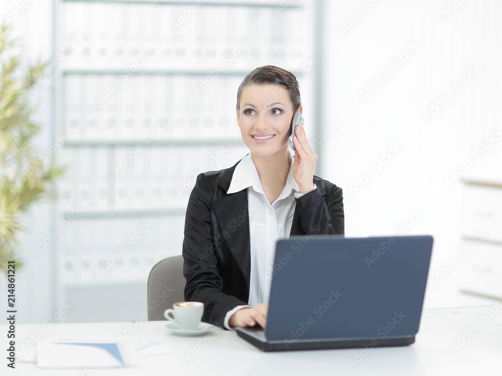 Executive business woman talking on mobile phone in office Executive business woman talking on mobile phone in office