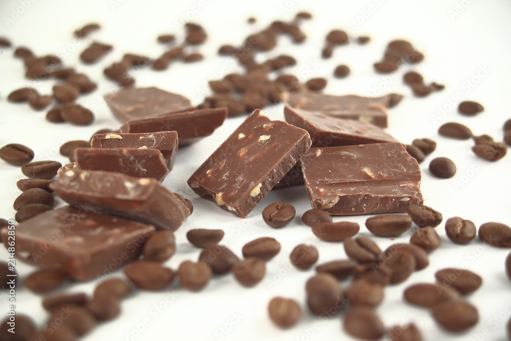 close up.pieces of chocolate and coffee beans isolated on white. close up.pieces of chocolate and coffee beans isolated on white.