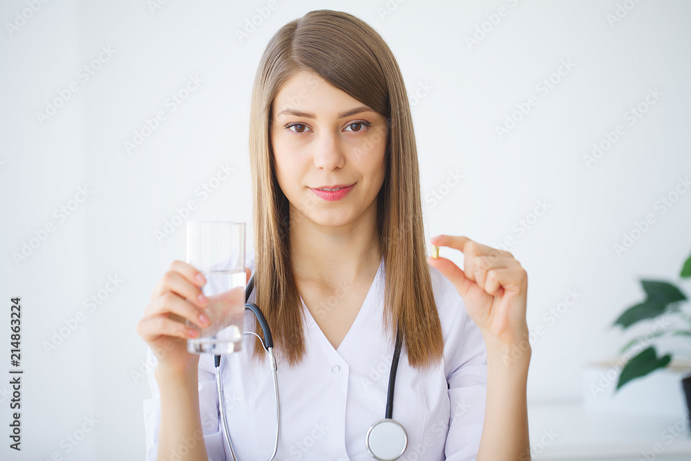 Clinic. Portrait of young doctor standing in medical office Clinic. Portrait of young doctor standing in medical office