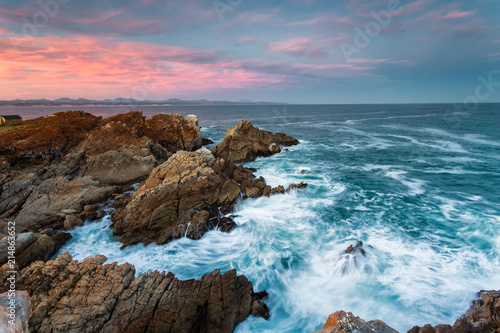 Wide angle landscape image of rock formations and the indian ocean along the Garden Route coast of South Africa photo