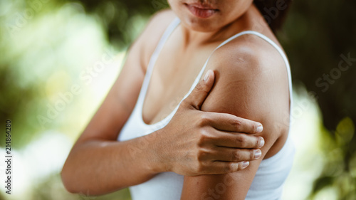 Woman with pain in shoulder and upper arm , Health Care Concept