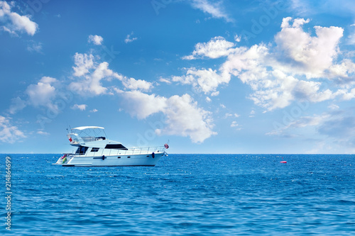 Yacht in the sea on a background of the sky with clouds.Vacation holiday concept.
