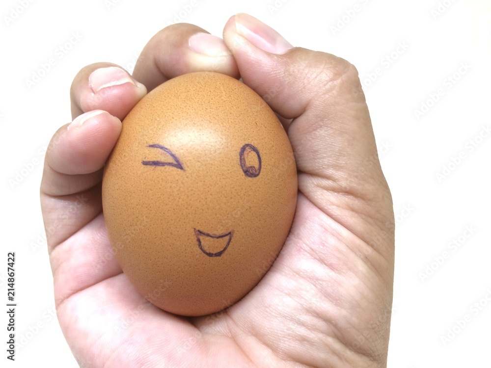 Face egg happy in hand isolated on white background. Face egg happy in hand isolated on white background.