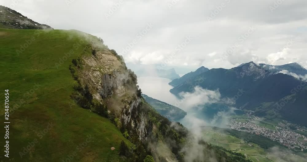 Sideways aerial pan shot of Lake Lucerne, Switzerland with fog and rocky cliff, on Fronalpstock. Sideways aerial pan shot of Lake Lucerne, Switzerland with fog and rocky cliff, on Fronalpstock.