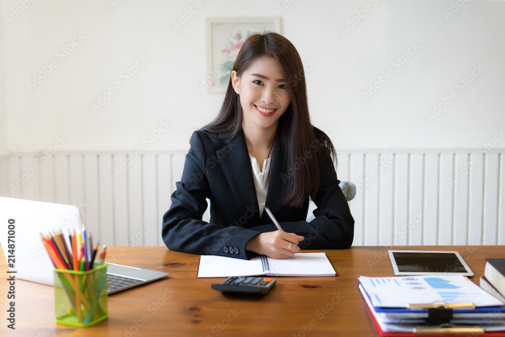 Asian business woman executives discussing financial reports and using calculator. Asian business woman executives discussing financial reports and using calculator.