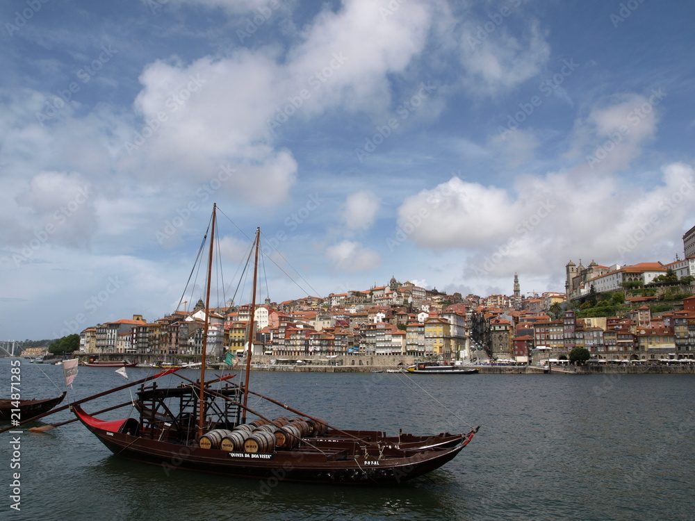 Traditional port wine ship in Douro River and beautiful cityscape of Porto, Portugal