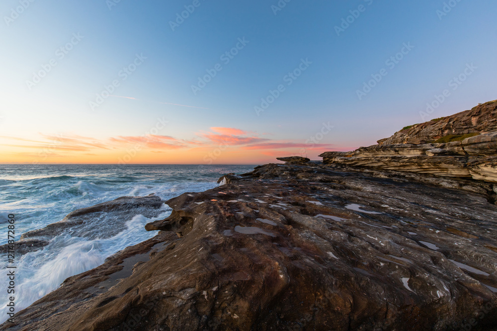 Morning view at small rock cliff by the beach.