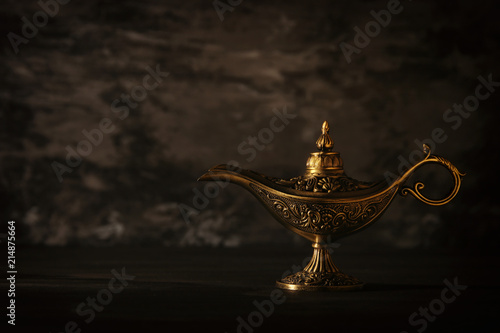 Image of magical mysterious aladdin lamp over black background. Lamp of wishes.